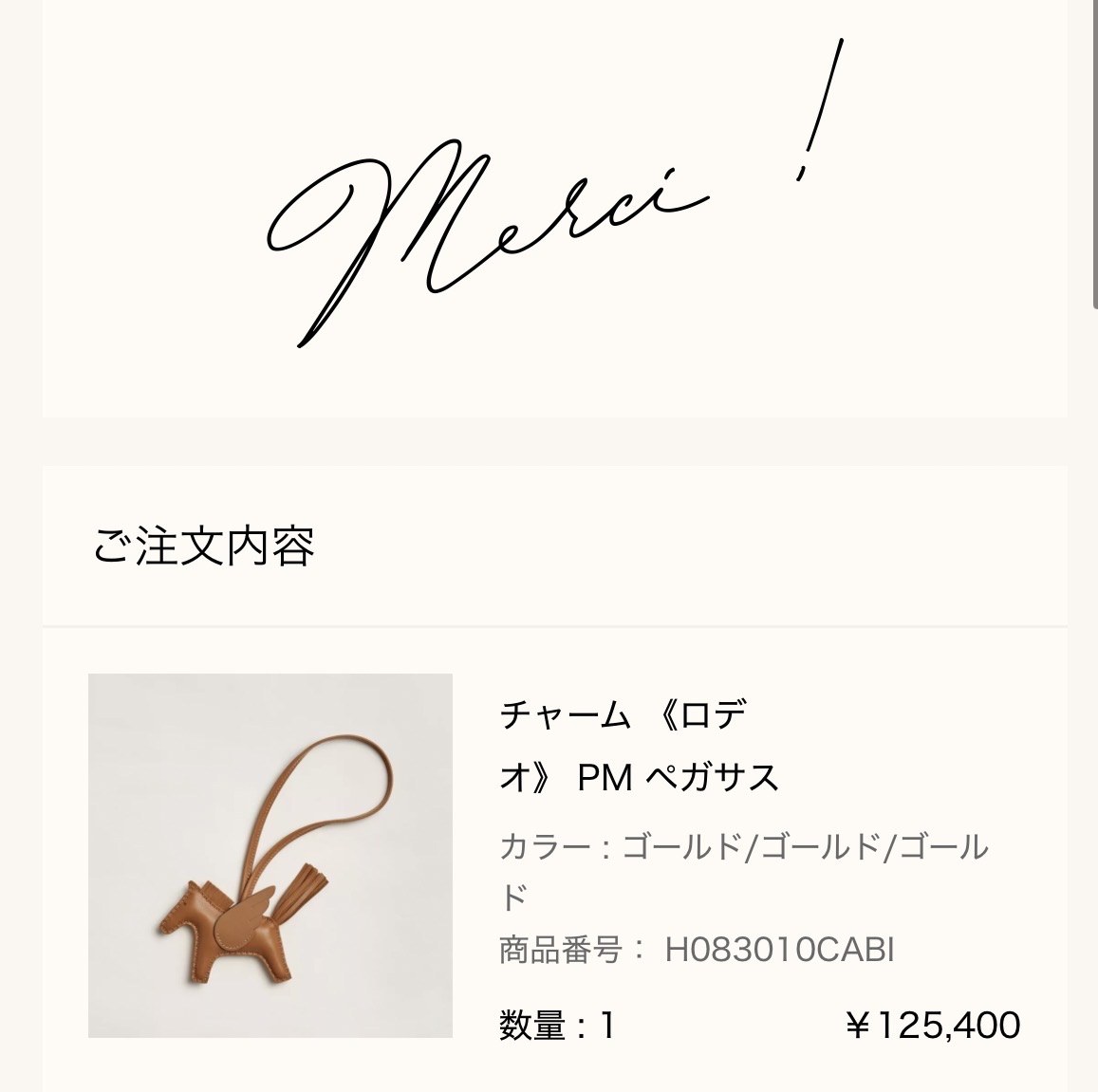 エルメス公式オンラインストアの注文完了画面（Merci !）: ご注文内容 チャーム《ロデオ》PM ペガサス（カラー ゴールド/ゴールド/ゴールド、商品番号 H083010CABI、数量1、¥125,400）